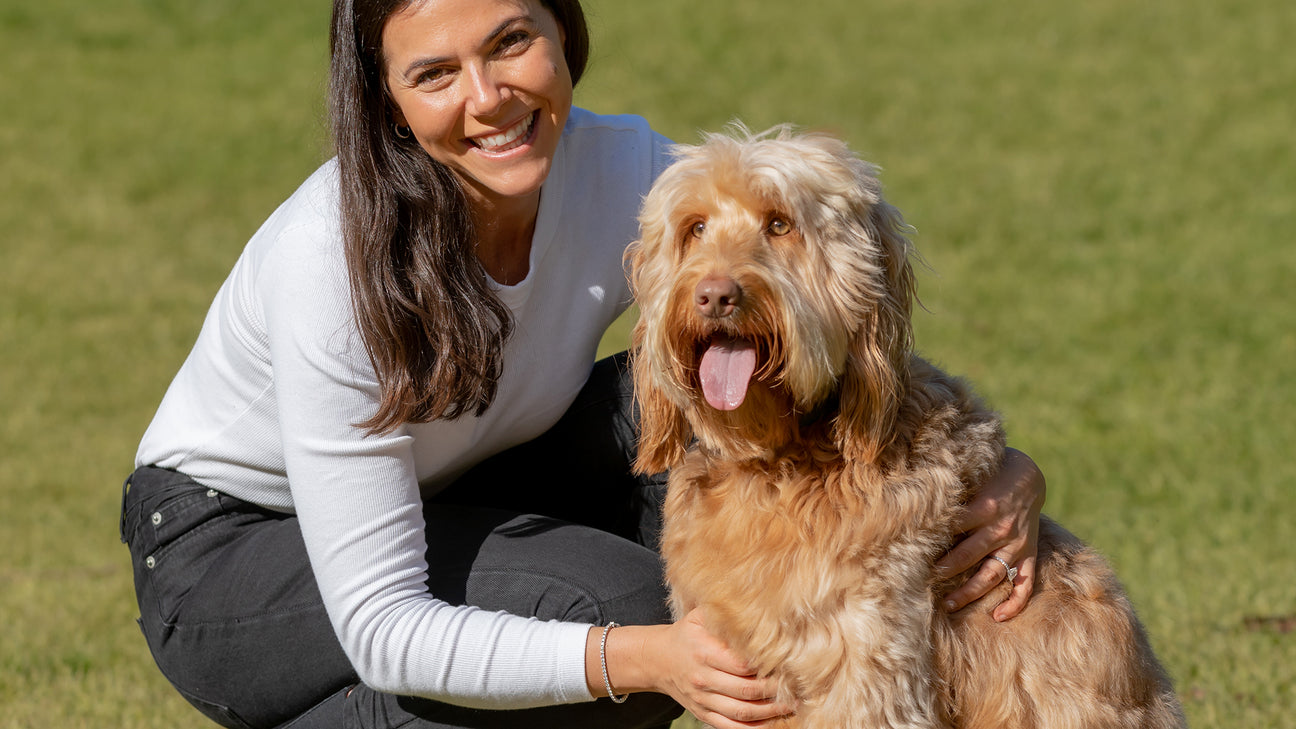 Founder of Bell & Bone feeding dog a dental treat